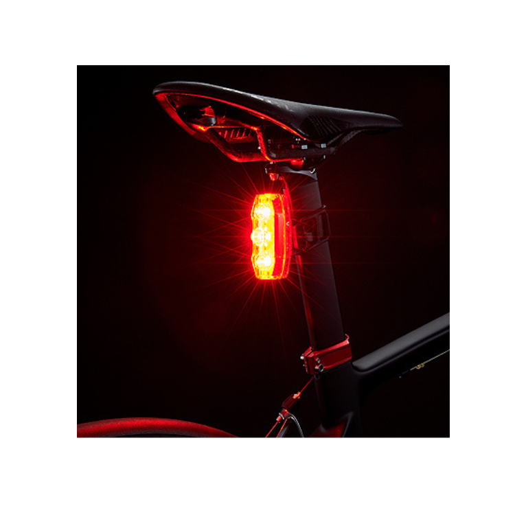 Cateye VIZ300 rear bike light glowing brightly to ensure safety during nighttime cycling.