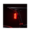 Cateye VIZ300 rear light glowing in dark conditions to ensure visibility and safety during nighttime cycling.
 