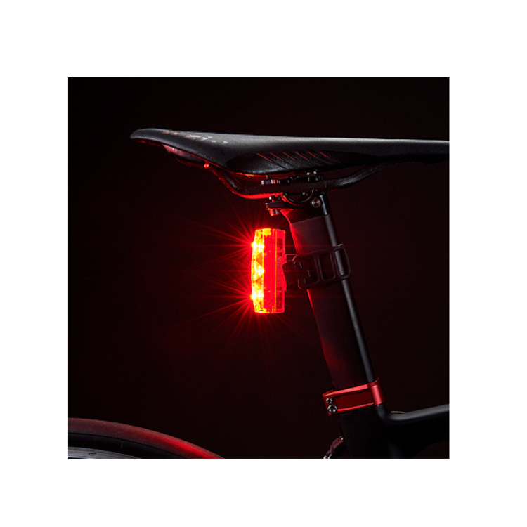 Cateye VIZ300 rear bike light illuminated with powerful LEDs for enhanced rider safety.