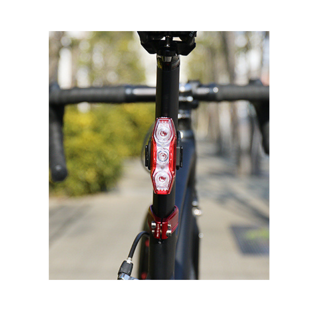 Cateye VIZ300 rear bike light mounted on the seat post for enhanced rider safety.