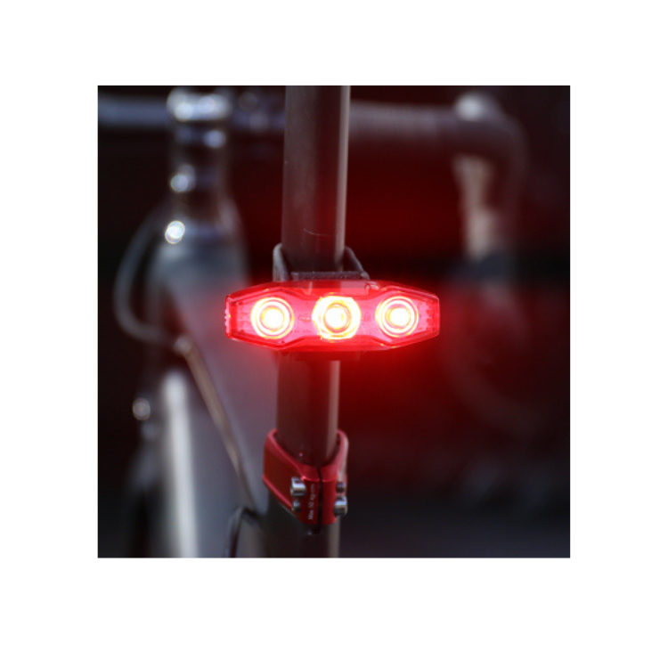 Cateye VIZ300 rear light providing bright red illumination for safe night cycling.