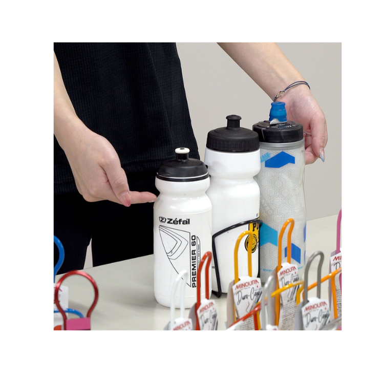 Close-up of Zéfal and insulated water bottles next to colourful Minoura bottle cages.