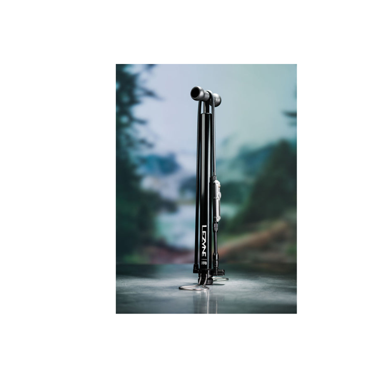 Studio shot of a tall black floor pump with digital gauge, positioned upright against a blurred backdrop.
