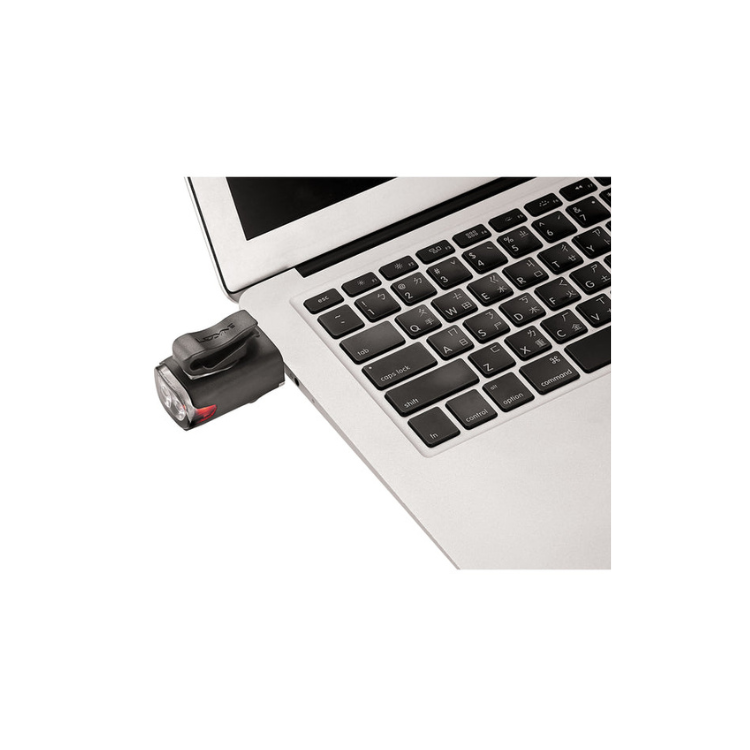 Lezyne LED front bike light attached to a laptop for easy USB charging, demonstrating its versatile design and compact form for cyclists.