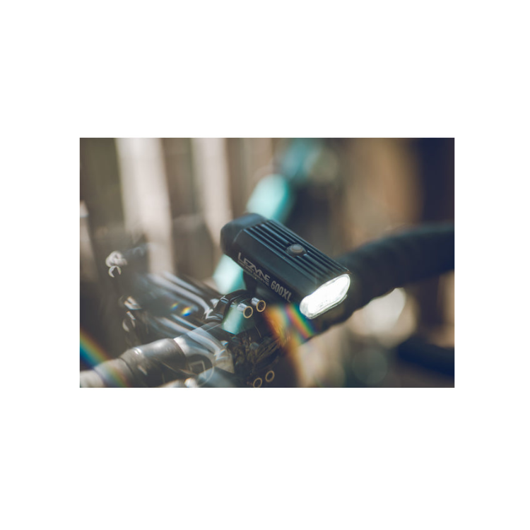 Lezyne Micro Drive 600XL front bike light mounted on the handlebar, showcasing bright LED light for enhanced cycling visibility.