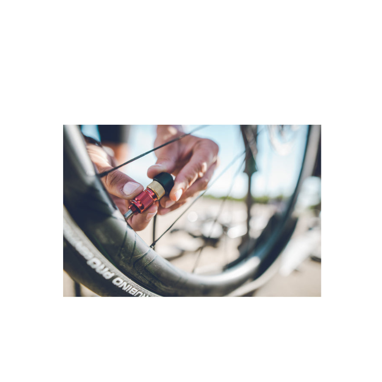 Close-up of cyclist using a Lezyne ABS pump chuck on a bicycle tire valve