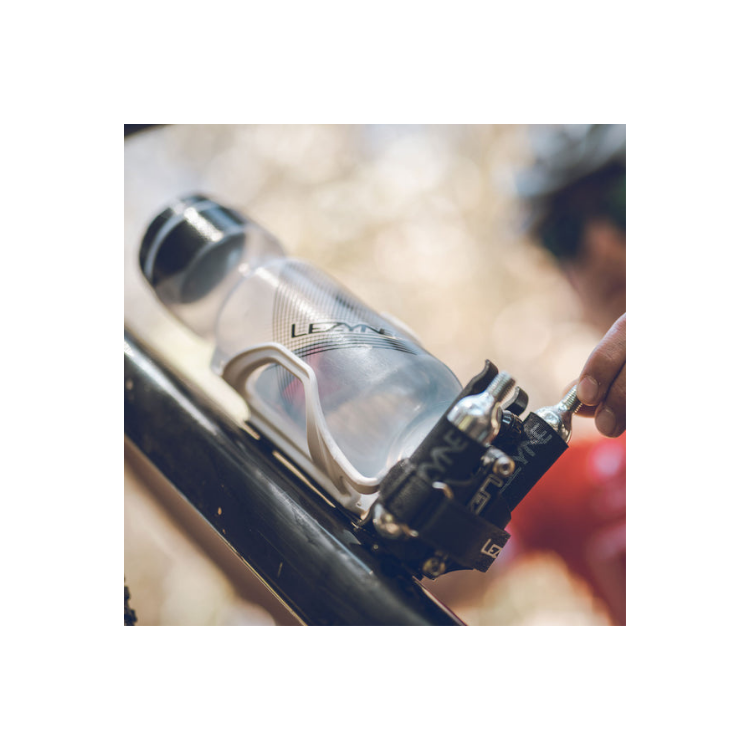 Rider using Lezyne CO2 kit mounted below a bottle cage on a bike frame.