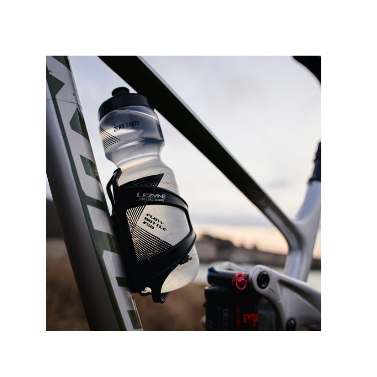 Close-up of Lezyne Flow bottle cage holding a water bottle on a bicycle frame.