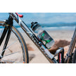 Lezyne Grip Drive HP mini pump securely mounted on a road bike frame next to a water bottle at the beach.