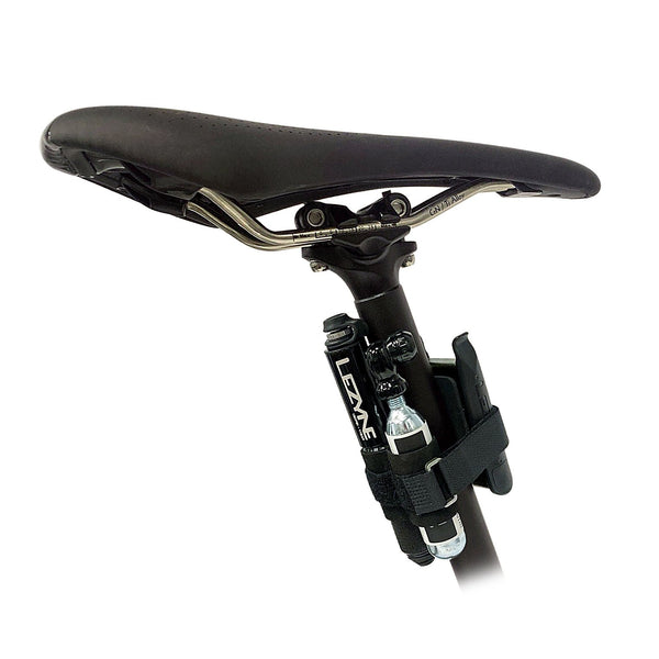 Compact Lezyne Pocket Drive kit with CO2 cartridge and tire levers securely strapped under a bicycle saddle for easy access.