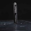 Black Lezyne Pocket Drive pump standing vertically on a wet reflective surface, showing its compact size and rugged grip.