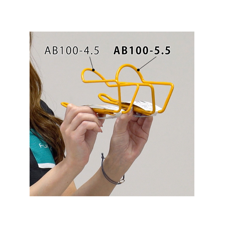 Comparison of yellow Minoura AB100-4.5 and AB100-5.5 bottle cages held side by side.
