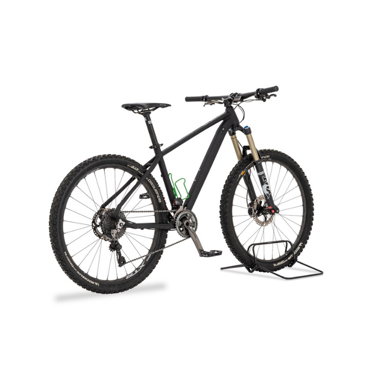 Black mountain bike equipped with a green Minoura AB100 bottle cage and supported by a front wheel bike stand.