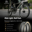 Person riding a bicycle with Nightpedal branding, featuring Panaracer Agilist tires.