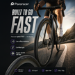 Bicycle with Panaracer Agilist FAST tires on a road, featuring text about tire features.