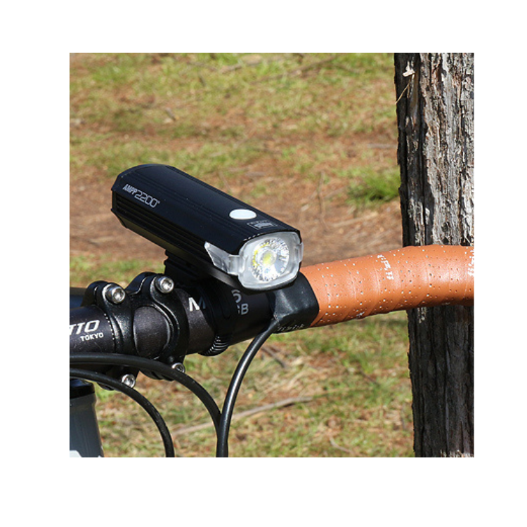 Cateye AMPP 2200 Front Light in Use - Cyclist using the Cateye AMPP 2200 front bike light during a night ride for optimal visibility.